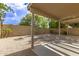 Low maintenance backyard features rock landscaping and a covered patio at 4387 E Hartford Ave, Phoenix, AZ 85032
