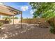 A charming backyard featuring a covered patio, a water fountain and desert landscaping at 4387 E Hartford Ave, Phoenix, AZ 85032