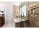 Beautiful bathroom features a soaking tub with a glass shower door, tile backsplash and neutral tile floors at 4387 E Hartford Ave, Phoenix, AZ 85032