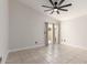Bright bedroom featuring neutral paint, a ceiling fan, tile flooring, and access to the backyard at 4387 E Hartford Ave, Phoenix, AZ 85032
