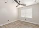 Bright bedroom with wood-look flooring and a ceiling fan at 4387 E Hartford Ave, Phoenix, AZ 85032