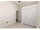This bedroom has tile floors, a standard closet, and a ceiling fan at 4387 E Hartford Ave, Phoenix, AZ 85032