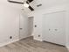 This bedroom includes wood-look flooring, a ceiling fan, and a standard closet at 4387 E Hartford Ave, Phoenix, AZ 85032