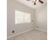 Bedroom with tile floors, a ceiling fan, and a large window at 4387 E Hartford Ave, Phoenix, AZ 85032