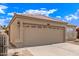 Home featuring a tile roof, tan stucco, two-car garage with low maintenance landscaping at 4387 E Hartford Ave, Phoenix, AZ 85032