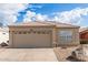 Charming home featuring a tile roof, tan stucco, a 2-car garage, and desert landscaping for low maintenance appeal at 4387 E Hartford Ave, Phoenix, AZ 85032