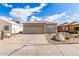 Charming home featuring a tile roof, tan stucco, a 2-car garage, and desert landscaping for low maintenance appeal at 4387 E Hartford Ave, Phoenix, AZ 85032