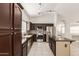 Modern kitchen featuring stainless steel appliances, an island, and dark cabinetry with ample storage at 4387 E Hartford Ave, Phoenix, AZ 85032