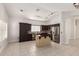 Well-lit kitchen boasting stainless steel appliances, dark cabinetry, and an island with a granite countertop at 4387 E Hartford Ave, Phoenix, AZ 85032
