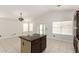 Kitchen island with marble countertop, cabinets, and room for bar stools, perfect for entertaining at 4387 E Hartford Ave, Phoenix, AZ 85032