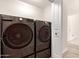 Laundry room featuring sleek, modern washer and dryer units at 4387 E Hartford Ave, Phoenix, AZ 85032