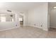 Spacious room featuring tile flooring, neutral walls, and an open floor plan at 4387 E Hartford Ave, Phoenix, AZ 85032