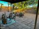 Backyard features a stone patio, multiple seating areas, desert landscaping, and block wall at 4901 W Corrine Dr, Glendale, AZ 85304