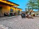 Relaxing backyard area with a covered patio, fire pit, and well-maintained landscaping at 4901 W Corrine Dr, Glendale, AZ 85304