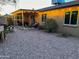 Backyard with covered patio, cozy seating, and a gravel landscape featuring a fire pit at 4901 W Corrine Dr, Glendale, AZ 85304