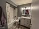 Elegant bathroom featuring a shower-tub combo, modern vanity, and updated fixtures at 4901 W Corrine Dr, Glendale, AZ 85304