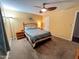 This bedroom features carpeted floors, ceiling fan, a bed, two nightstands, and a decorative mirror at 4901 W Corrine Dr, Glendale, AZ 85304