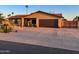Well-maintained house featuring a two-car garage, desert landscaping, and a spacious driveway at 4901 W Corrine Dr, Glendale, AZ 85304