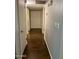 Hallway with wood flooring, multiple doorways, and a closet at 4901 W Corrine Dr, Glendale, AZ 85304