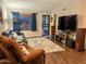 Comfortable living room with a plush rug, ample seating, and natural light from the window at 4901 W Corrine Dr, Glendale, AZ 85304