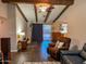Spacious living room featuring exposed wood beams, cozy furniture, and access to the backyard at 4901 W Corrine Dr, Glendale, AZ 85304