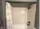 Shower features white subway tiles, black fixtures and a white shower curtain at 4901 W Corrine Dr, Glendale, AZ 85304