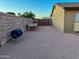 Spacious side yard featuring gravel ground covering and a privacy fence and gate at 4901 W Corrine Dr, Glendale, AZ 85304