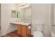 Bathroom featuring wood cabinets, a mirror, and a toilet at 514 N 112Th Dr, Avondale, AZ 85323