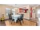 Bright dining room features hardwood floors, pendant lighting, and a view of the adjacent kitchen at 514 N 112Th Dr, Avondale, AZ 85323