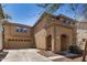 View showcasing the home's architecture, attached garage, desert landscaping, and welcoming entrance at 514 N 112Th Dr, Avondale, AZ 85323