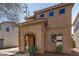 Front exterior view of the home with an arched entryway and desert landscaping at 514 N 112Th Dr, Avondale, AZ 85323