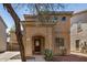 Charming two-story home featuring an arched entryway, tile roof, and desert landscaping at 514 N 112Th Dr, Avondale, AZ 85323