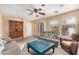 Comfortable living room featuring neutral tones, ceiling fan, and sliding glass door at 514 N 112Th Dr, Avondale, AZ 85323