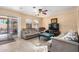 Inviting living room with neutral decor, a ceiling fan, and access to the outdoor space at 514 N 112Th Dr, Avondale, AZ 85323