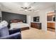 Bedroom features a ceiling fan, neutral carpet, ample natural light, and en suite bath at 514 N 112Th Dr, Avondale, AZ 85323
