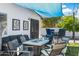 Backyard area featuring an outdoor seating area with a fire pit, barstool seating, and shade canopies at 5320 E Thomas Rd, Phoenix, AZ 85018