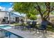 Inviting backyard with pool, lounge chairs, mature trees, and an outdoor entertainment area at 5320 E Thomas Rd, Phoenix, AZ 85018