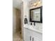 Bathroom showcasing vanity with stylish fixtures, marble countertop, a walk-in shower and neutral tile at 5320 E Thomas Rd, Phoenix, AZ 85018
