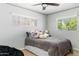 Cozy bedroom with a comfortable bed, decorative pillows, and a ceiling fan at 5320 E Thomas Rd, Phoenix, AZ 85018