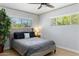 Bedroom features a bed with upholstered headboard, neutral bedding, and an abundance of natural light at 5320 E Thomas Rd, Phoenix, AZ 85018