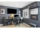 Comfortable home office with large monitor, shelving, decor, desk and lots of natural light from the exterior window at 5320 E Thomas Rd, Phoenix, AZ 85018