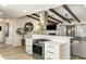 Modern kitchen with stainless steel oven and a view into the cozy living room at 5320 E Thomas Rd, Phoenix, AZ 85018