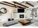 Comfortable living room with a fireplace, ceiling beams, and stylish decor at 5320 E Thomas Rd, Phoenix, AZ 85018