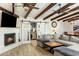 Inviting living room featuring a fireplace, wood beams, and sliding barn doors at 5320 E Thomas Rd, Phoenix, AZ 85018