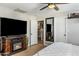 Comfortable bedroom featuring a fireplace, TV, and neutral decor at 5320 E Thomas Rd, Phoenix, AZ 85018