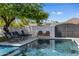 Inviting backyard pool area, showcasing lounge seating, a tranquil setting, and privacy fencing at 5320 E Thomas Rd, Phoenix, AZ 85018