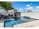 Sparkling pool with tile trim, patio, and privacy wall offers a refreshing backyard retreat at 5320 E Thomas Rd, Phoenix, AZ 85018