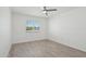 Bright bedroom featuring fresh white walls, a modern ceiling fan, and wood-look flooring at 610 E Montebello Ave # 46, Phoenix, AZ 85012
