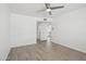 This bedroom features hardwood floors, a ceiling fan, and a wide doorway for easy access at 610 E Montebello Ave # 46, Phoenix, AZ 85012