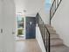 Bright foyer with staircase featuring wood laminate flooring, modern lighting, and a view to the outside at 610 E Montebello Ave # 46, Phoenix, AZ 85012